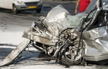Damaged vehicle closeup after car crash.