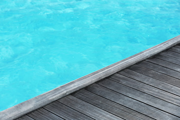 Fototapeta na wymiar Wooden pontoon at sea resort. Summer vacation concept