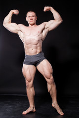 the athlete bodybuilder shows his muscles after sports