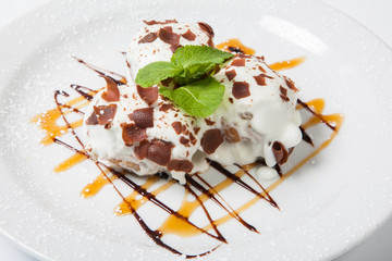 Ice cream with Chocolate topping.Dessert is on the white plate