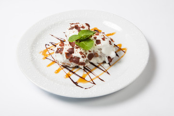 Ice cream with Chocolate topping.Dessert is on the white plate