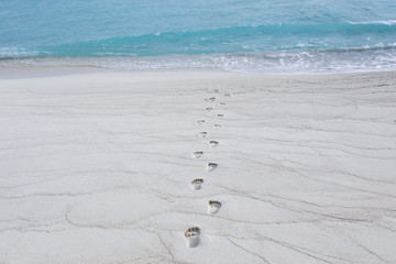 Human footprints on beach sand at resort
