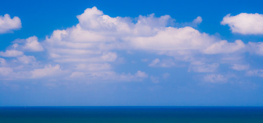 Ocean blue with white clouds above