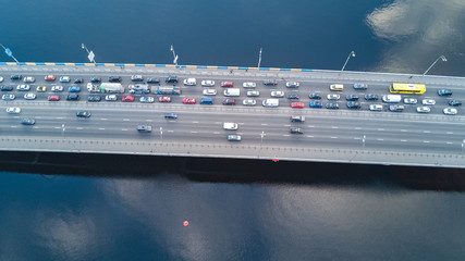 Fototapeta premium Aerial top view of bridge road automobile traffic of many cars, transportation concept 