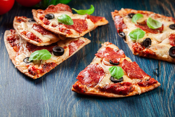 Slices of pizza pepperoni with olives