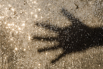 Shadow of a hand on a metallic background