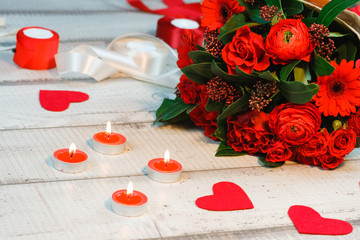 A beautiful bouquet of red roses lies. Candles, holiday