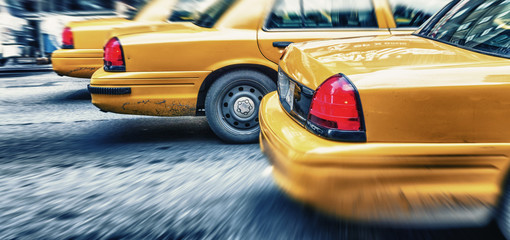 Yellow cabs in city avenue fast speeding, New York City