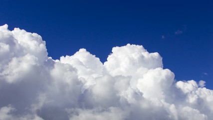 Fototapeta na wymiar a big and fluffy cumulonimbus cloud in the blue sky