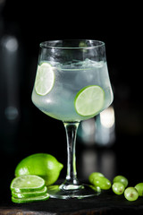 Green lime lemonade cocktail ice tonic on dark background