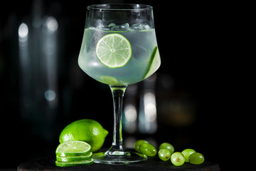 Green lime lemonade cocktail ice tonic on dark background