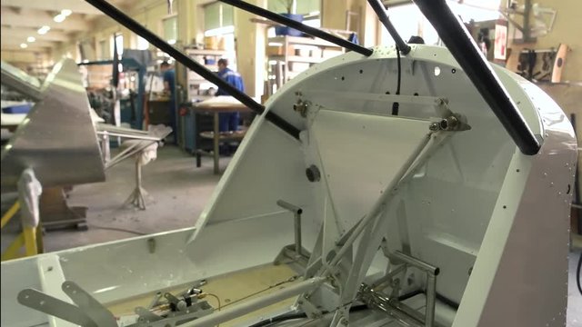 Part of airplane in workshop. Aircraft cockpit during construction. Modern aviation industry.