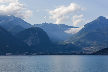 Picturesque evening view of the Lake Garda on the cliff mountains background, Italy