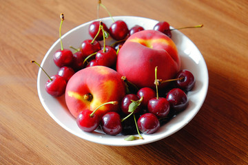 the cherries and peaches on a plate