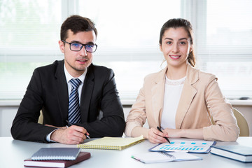 Business people are looking into the camera