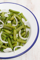 boiled green beans in dish on wooden background