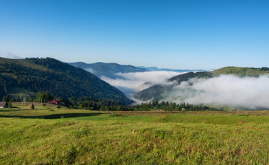 Fog and Clouds with mountain at sunrise in in Carpathians