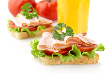 Toasts,cold cuts,parsley with orange juice on white