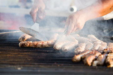 Sausages are fried on a barbecue