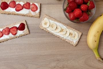 Healthy food. Fruit cut into bread and biscuits. A delicious dessert. Strawberry. Bananas. Fruits on a wooden background.Healthy food. Fruit cut into bread and biscuits. 