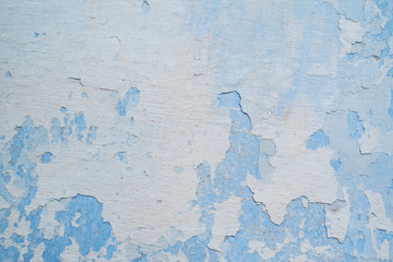 White blue wall with scratches and cracks