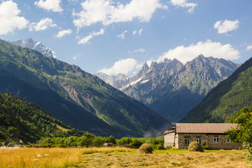 Caucasus mountains and old house in svaneti village Mestia landscape