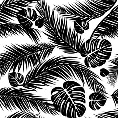 Obraz premium Seamless pattern with silhouettes of palm tree leaves in black on white background.Seamless Floral Background. Vector illustration