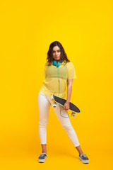 Trendy hipster posing with longboard