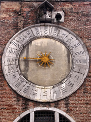 old church clack in murano burano venice with single gold hand and 24 hour dial with roman numerals in a brick tower