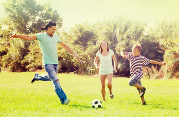 Family with teenager playing in soccer
