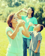 ordinary family of three drinking water