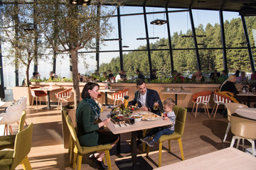 Young parents enjoying lunch time with their children