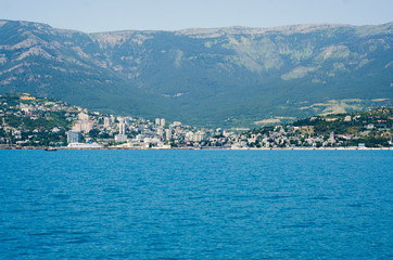 Fototapeta premium The city by the sea the sky is reflected in the water