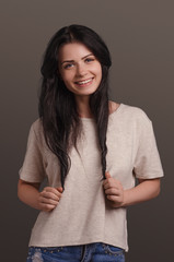 Fototapeta premium Young attractive girl smiling on a brown background. Portrait. Beautiful woman.