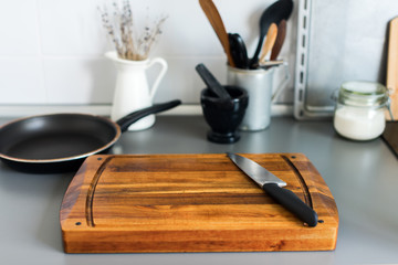 Obraz na płótnie Canvas Chopping Board and Knife on Grey Table-top Kitchen