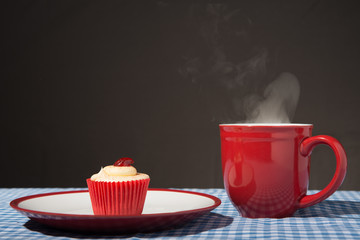Red mug with iced cupcake