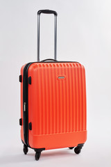 Personal luggage bag, white background. Modern red suitcase with handle. Case for tourism.