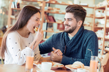Happy young couple enjoying breakfast