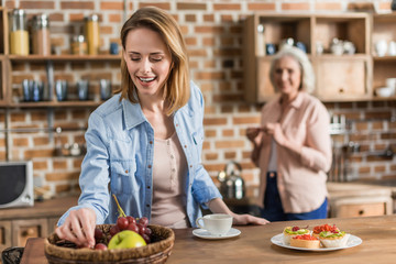 two women, senior and young having good time in kitchen