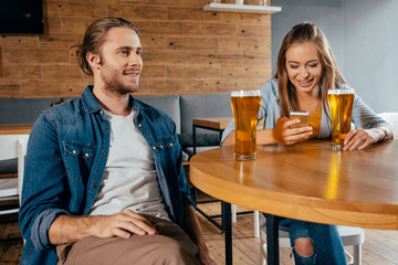 Happy young couple spending good time together in cafe