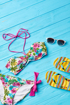 Floral bra and bikini,colorful background. Female accessories for sunbathing.