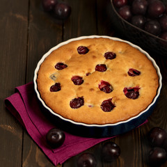 Rustic style. Homemade plum cake on a purple linen napkin.