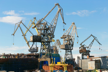 St. Petersburg, Russia - 28 June 2017: port cranes operate on the Neva River in St. Petersburg.