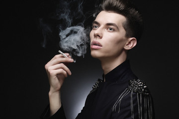 Young stylish man smoking a cigarette