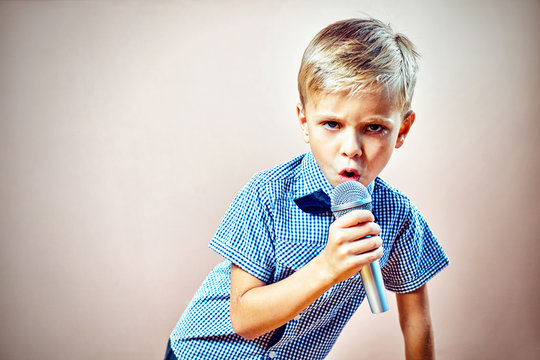 The Child Sings Into The Microphone