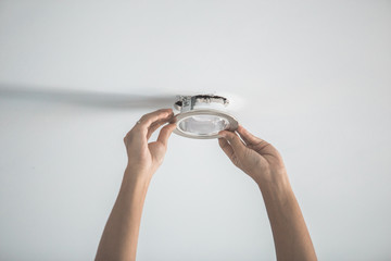 Male hands installing socket for light bulb