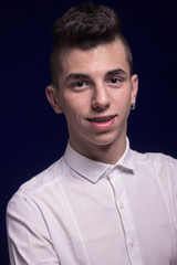 Obraz premium One teenager boy, head and shoulders shot, white shirt, earring
