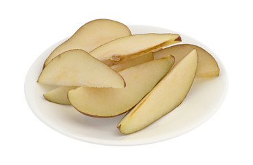 Red pear slices on a white plate isolated on a white background.
