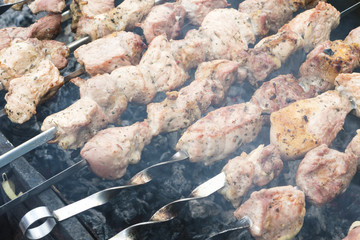 Skewers of pork or meat fried on a barbecue on the grill, barbecue