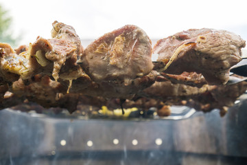 Skewers of pork or meat fried on a barbecue on the grill, barbecue